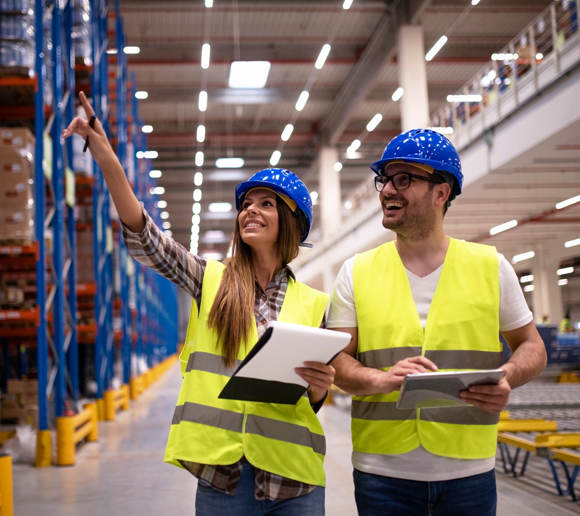 warehouse-workers-protective-uniform-walking-through-large-distribution-center-organizing-goods-distribution warehouse-workers-protective-uniform-walking-through-large-distribution-center-organizing-goods-distribution